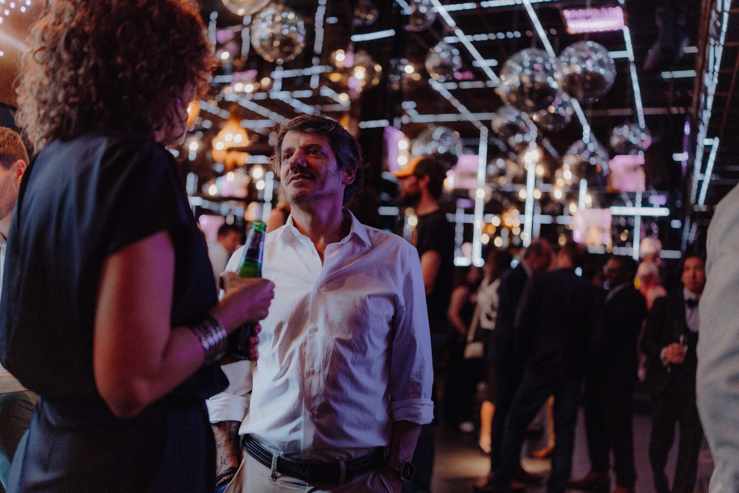 Guests mingling in the lounge area with ambient lighting