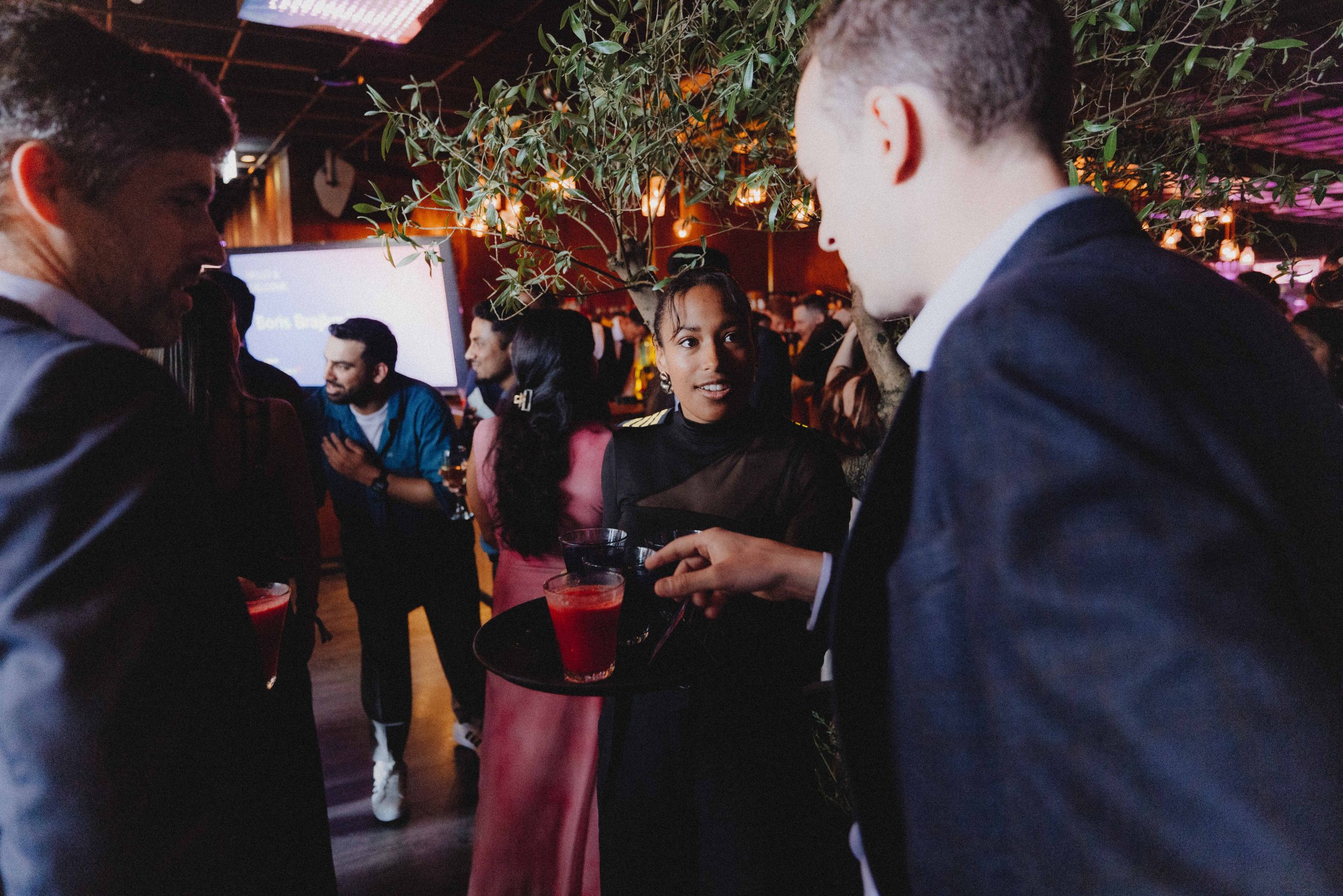 Staff welcomes the guests with a choice of signature drinks.